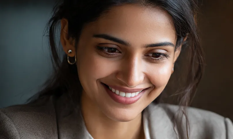 A business owner smiling at her laptop